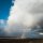 Beautiful-wide-shot-of-a-rainbow-among-white-clouds-in-a-cle