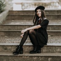 Sitting-on-the-steps-smile-black-haired-girl-young-fashionis