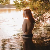 young-sensual-woman-in-lake-at-sunset-cavan-images